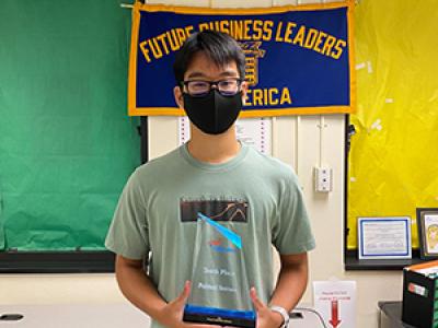 student with trophy