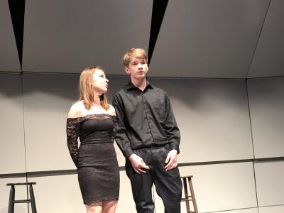 Girl and boy student singing duet