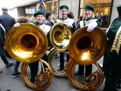 Tuba players getting ready to march in parade.