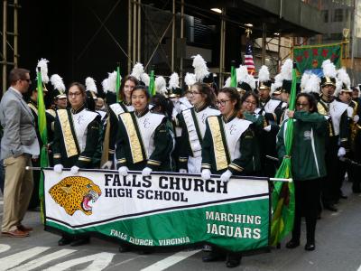 Students holding Falls Church High School banner.